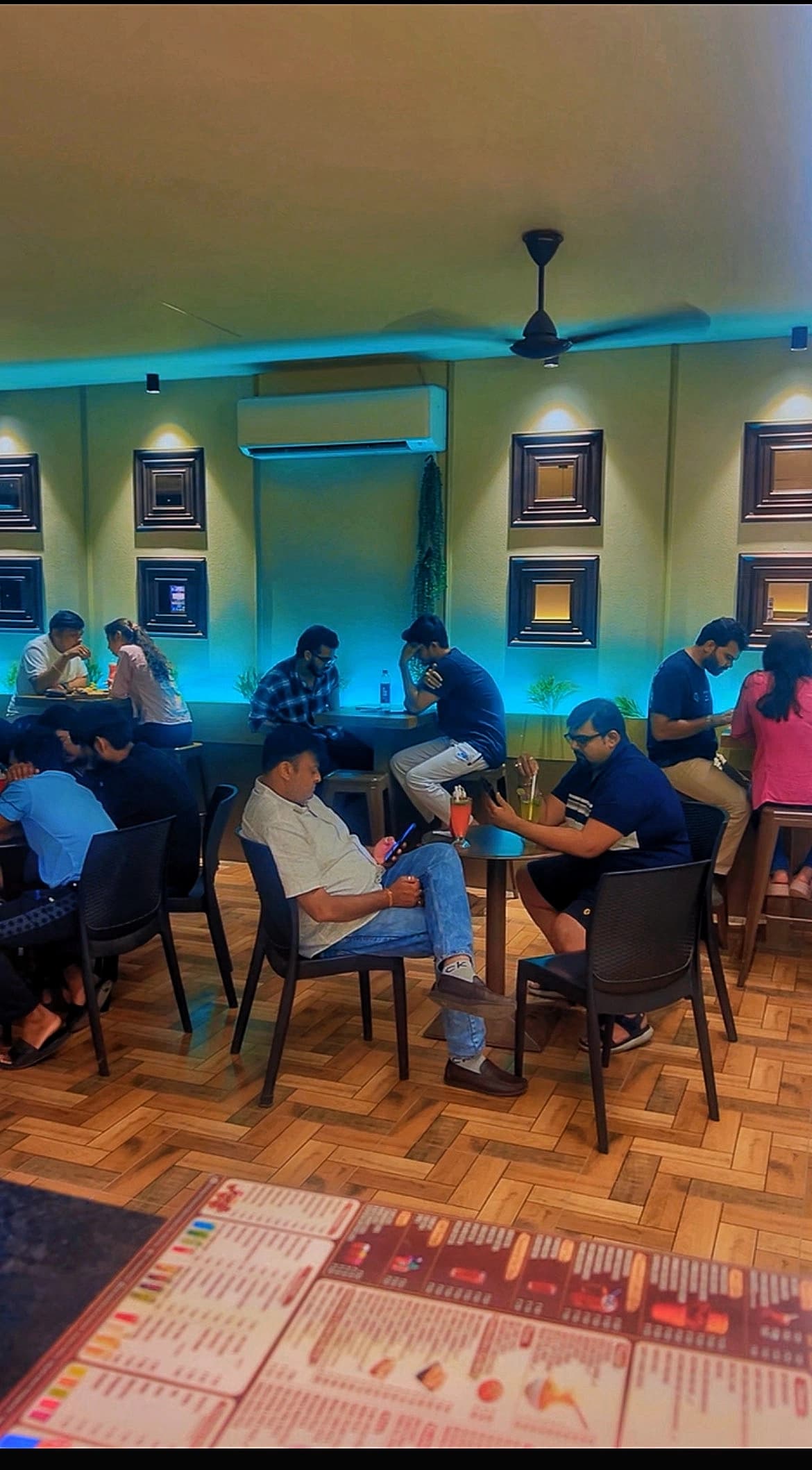 Customers enjoying the seating area inside Chai Sutta Bar Bharuch