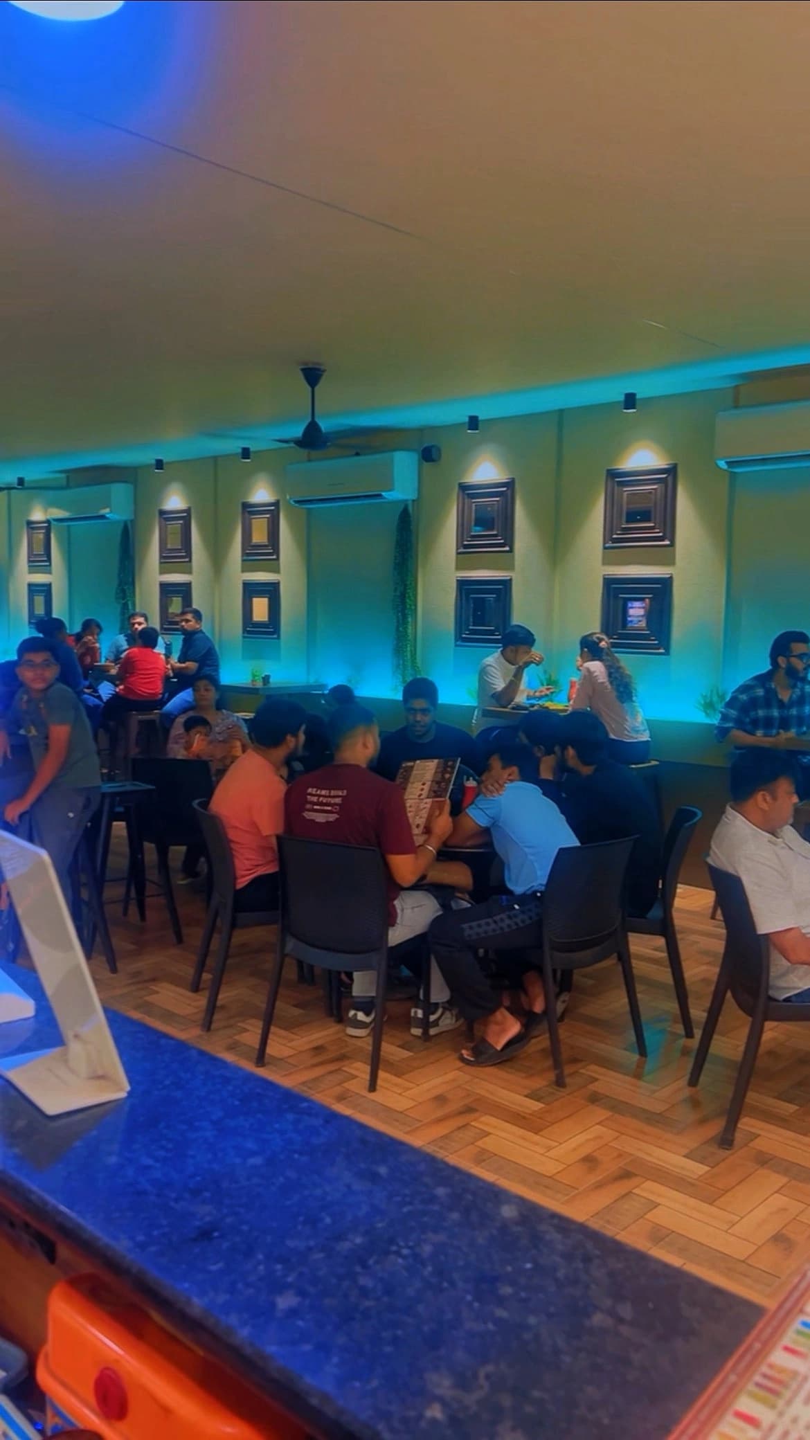 Busy cafe seating and customers at Chai Sutta Bar Bharuch